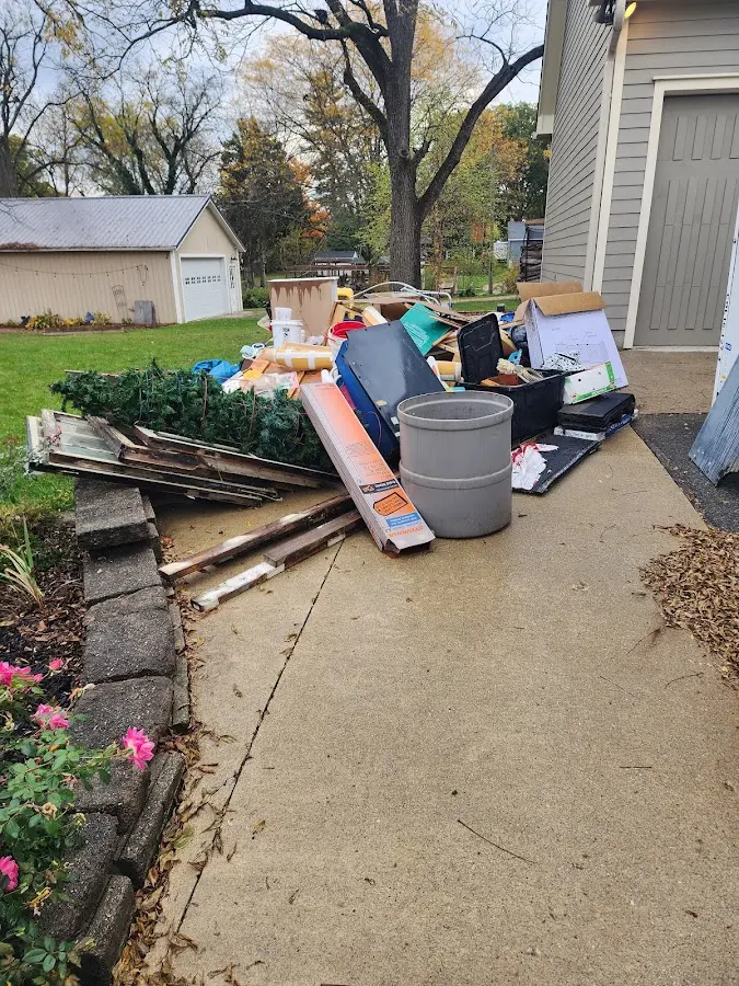 Dumpster being loaded with debris for Roofing Dumpster Rental in Park Ridge